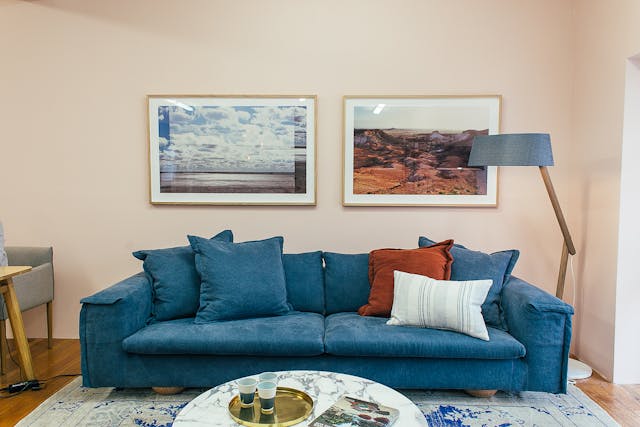 a%20living%20room%20with%20a%20blue%20couch%20two%20landscape%20paintings a%20living%20room%20with%20a%20blue%20couch%20two%20landscape%20paintings